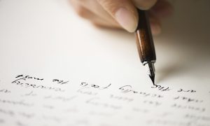 person writing a letter